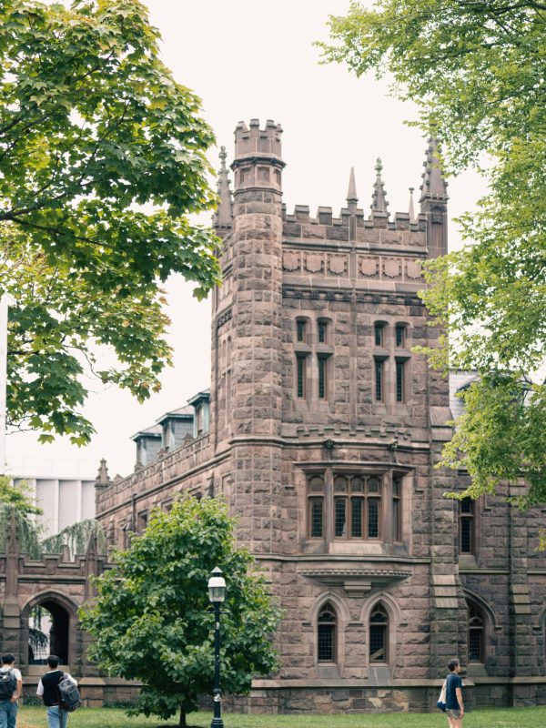 pexels-photo-28176025-28176025 Elegant gothic university building surrounded by lush greenery in an urban park setting, perfect for travel exploration.
